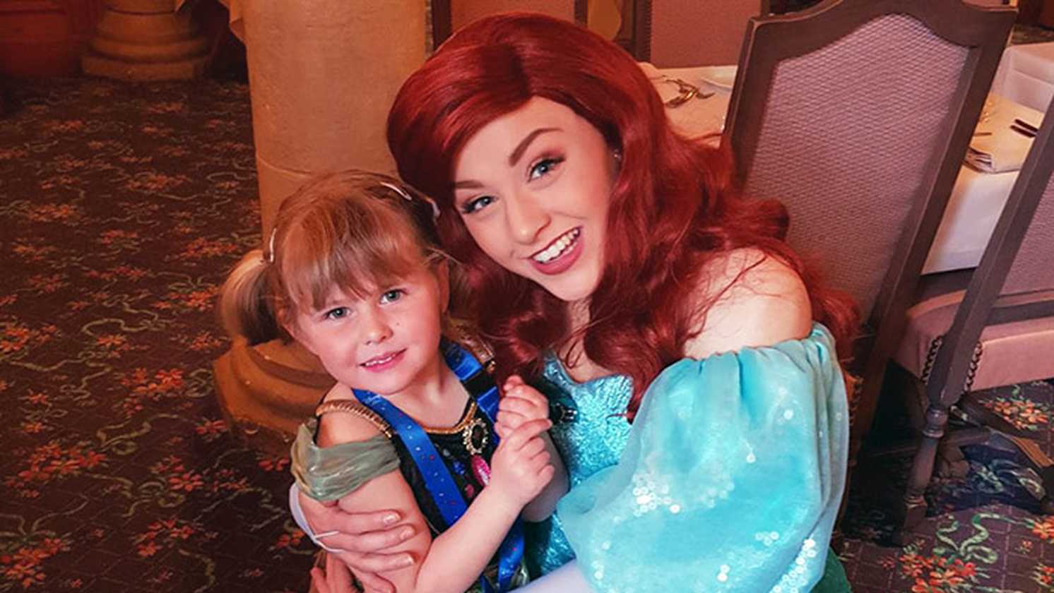 Poppy being hugged by Ariel