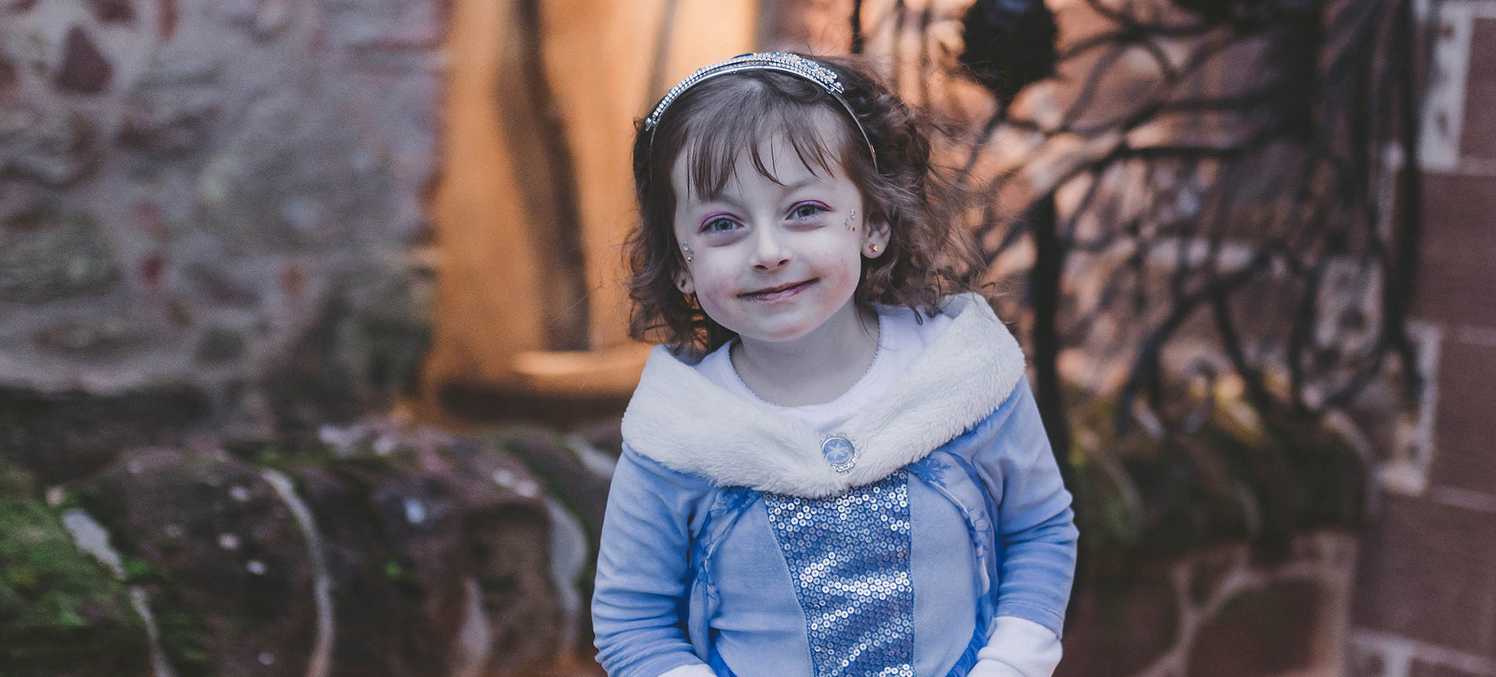 Wish child, Alyssia dressed in a blue princess dress and tiara.