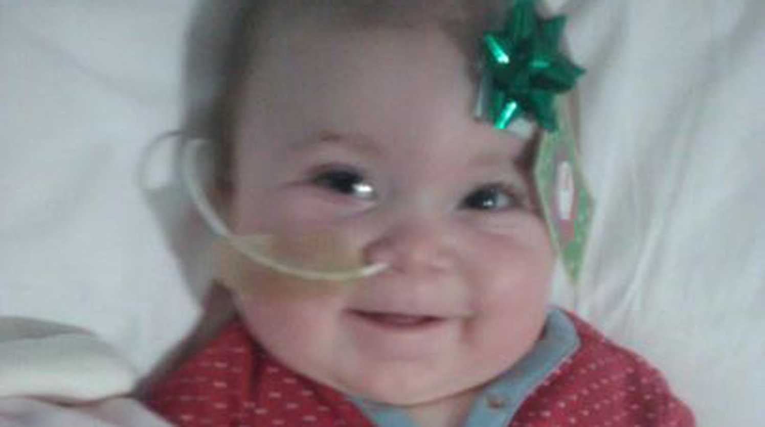 April in hospital with a bow on her head