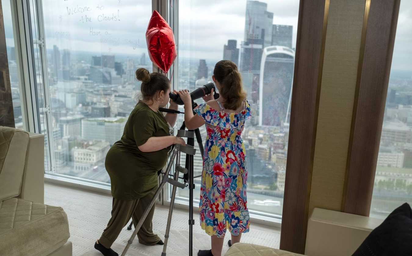 Angel an Mikayla admiring the view through a telescope.