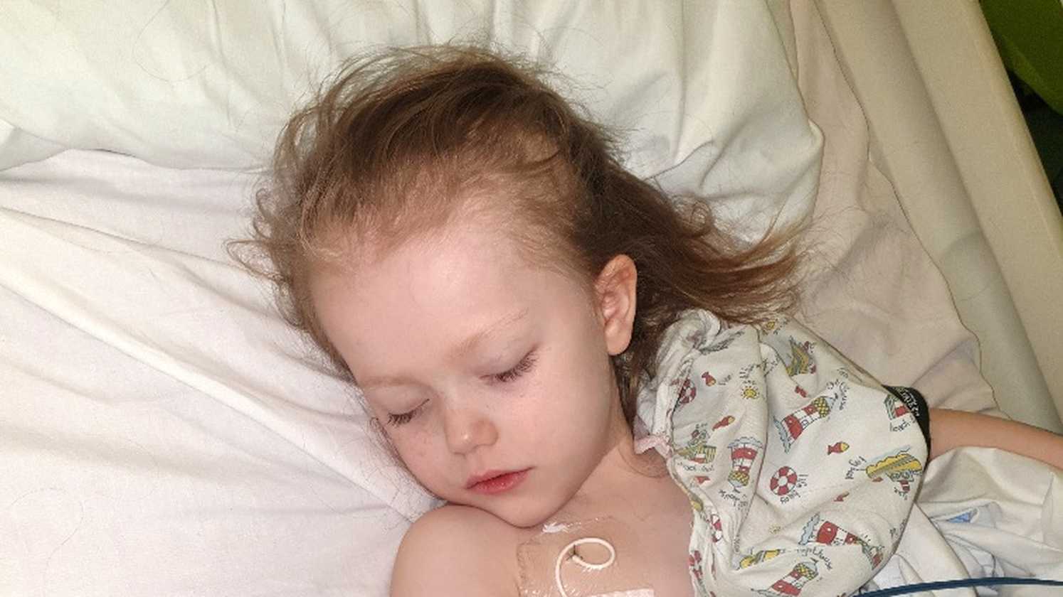 Lottie, sleeping in her hospital bed during treatment