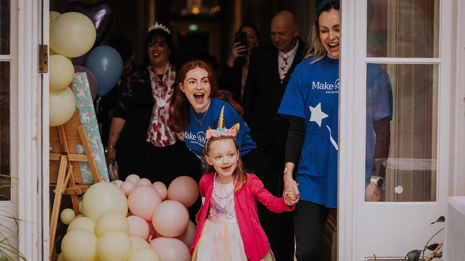 Lacey steps through a doorway glancing ahead at her wish