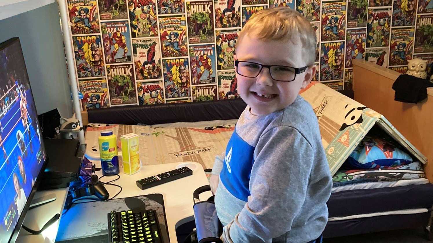 A smiling Harrison in front of his new gaming PC.
