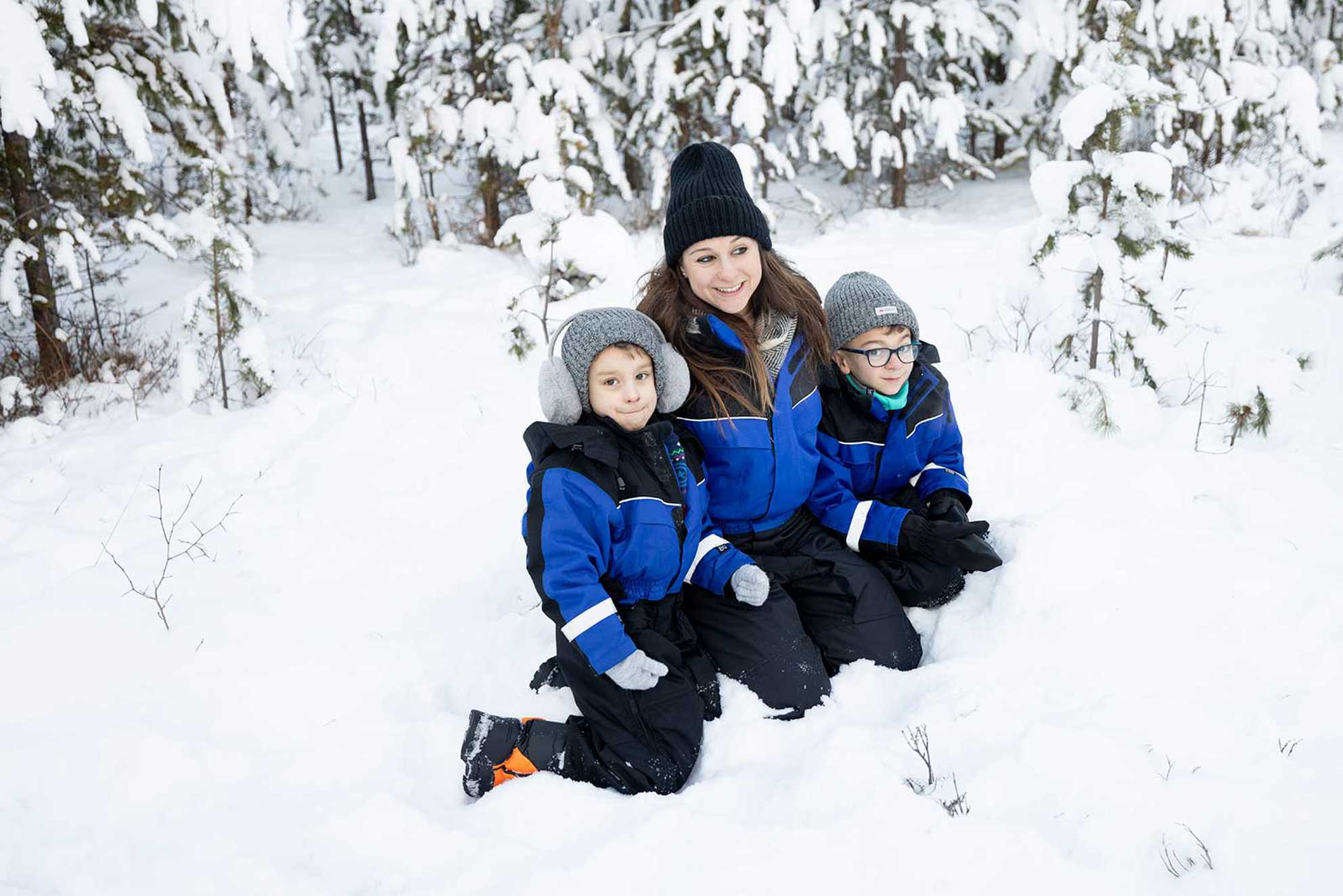 A group shot of mum and the children against a snowy backdrop.